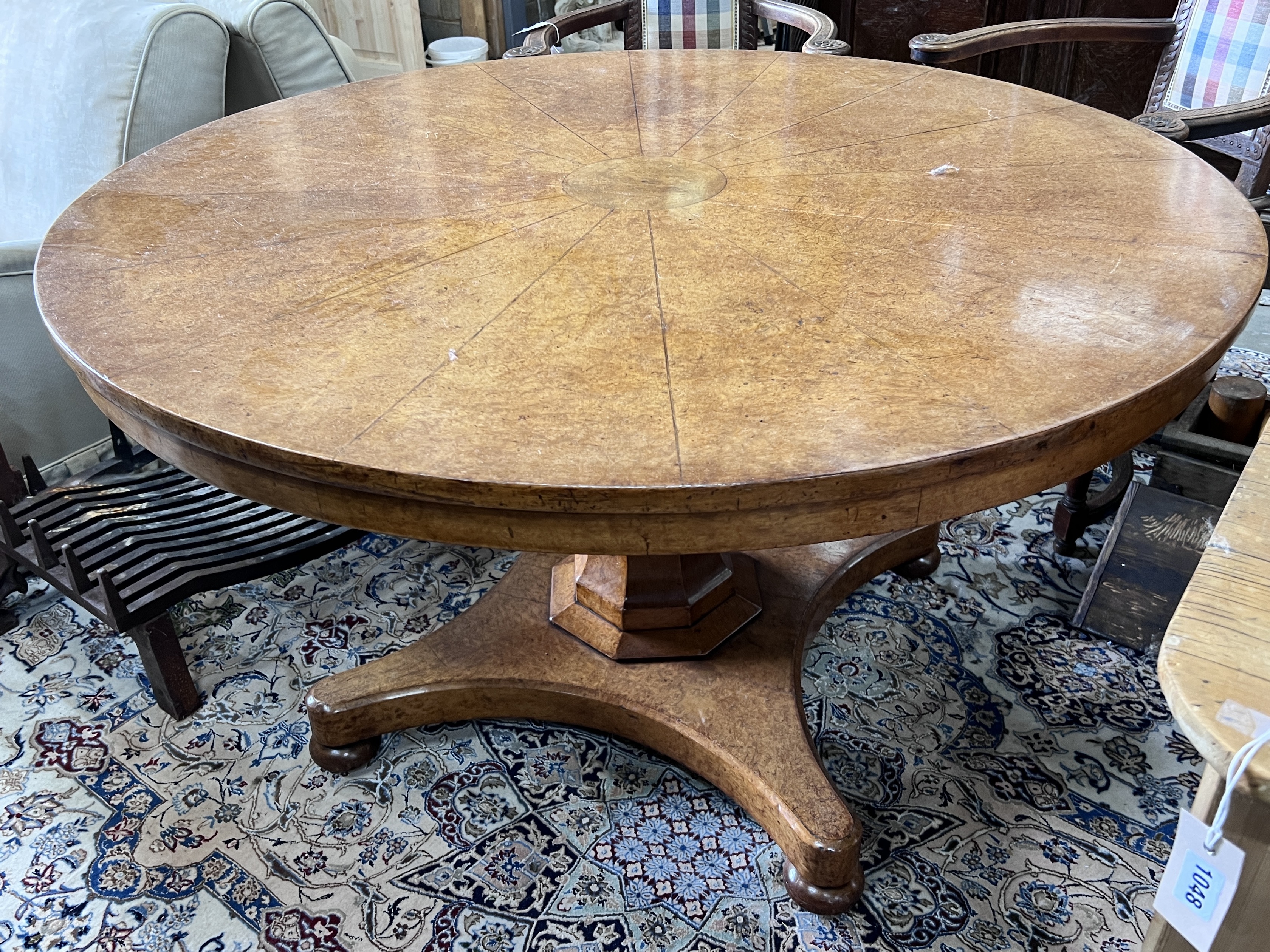 An early Victorian circular bird's eye maple circular breakfast table, with a segmented veneered top, diameter 128cm, height 74cm